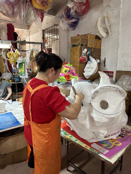 Artisan constructs the head of a Chinese dancing lion