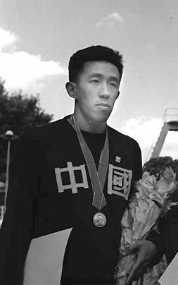 Wu Chuangyu, a Chinese swimmer of the 1952 Olympics wearing a medal and China sweater