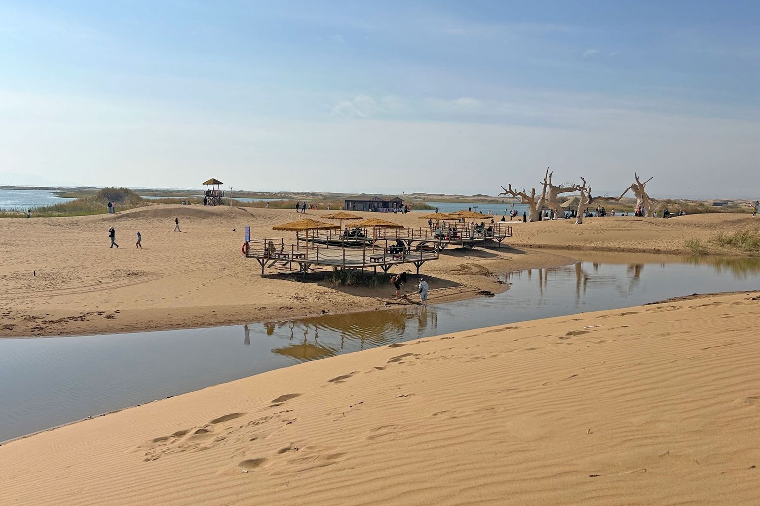 Lake water meets dunes on the western bank, a rare sight anywhere else in China