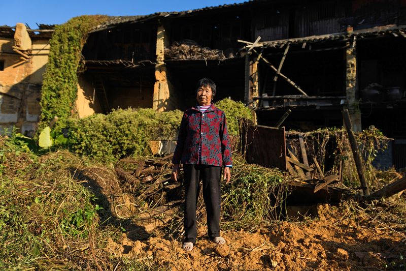 Lin Yin in front of an abandoned and dilapidated “tulou” dwelling