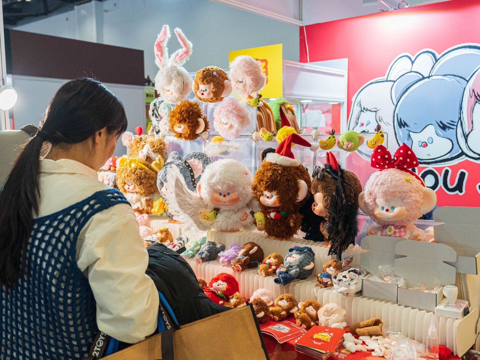 Young Chinese purchasing designer toys and plushies