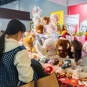 Young Chinese purchasing designer toys and plushies