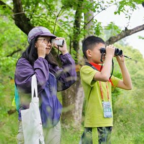 Young Chinese birding at a park