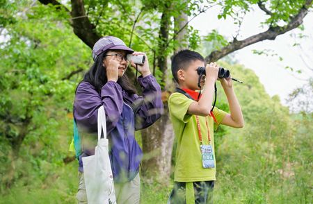 Young Chinese birding at a park
