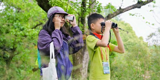 Young Chinese birding at a park