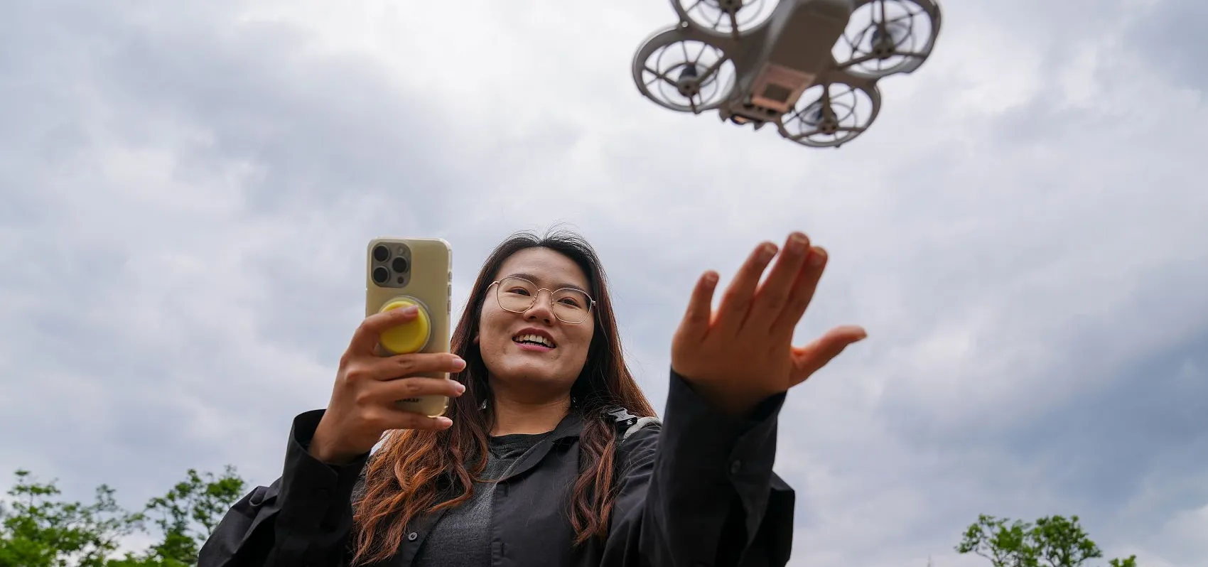 Young Chinese woman flying rental drone