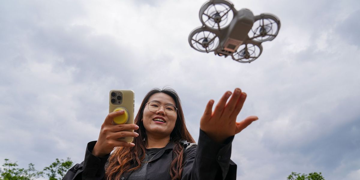Young Chinese woman flying rental drone