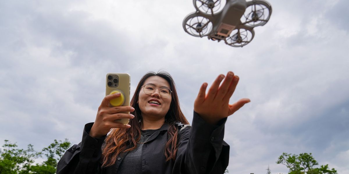 Young Chinese woman flying rental drone