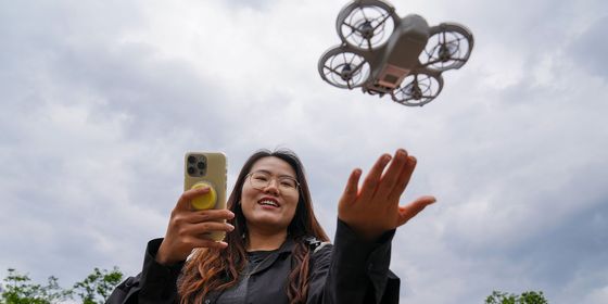Young Chinese woman flying rental drone