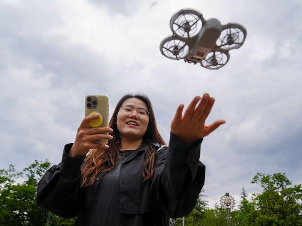 Young Chinese woman flying rental drone