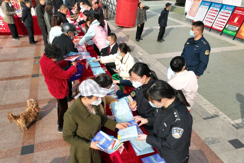 Local police in Yangzhou, Jiangsu province, handing out pamphlets explaining the Anti-Domestic Violence Law and other laws for the protection of women’s rights on the International Women’s Day 2023