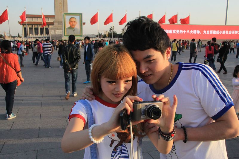 Tiananmen Square in Beijing gets special decorations for the Labor Day holiday. Here a couple takes a photo in 2013