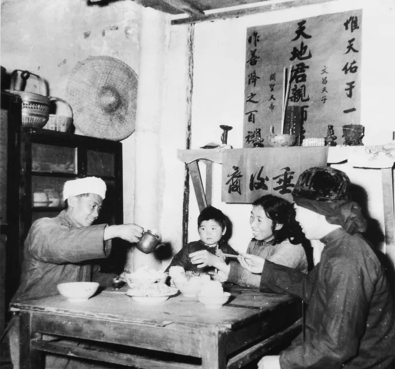 A family eating a New Year’s dinner during the Republican Era