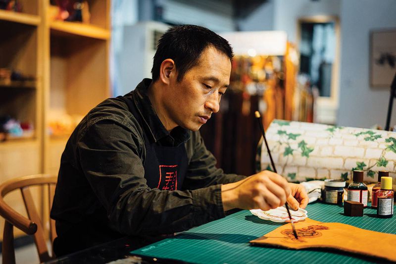 Zhou colors a Tang-style floral scroll, his favorite pattern