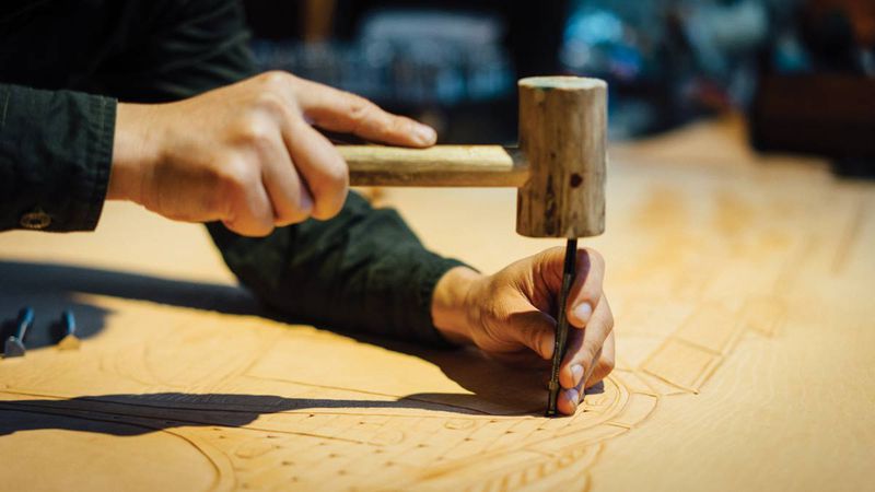 Carving on leather, unlike wood, is not a process of subtraction; instead, patterns are imprinted via various molds