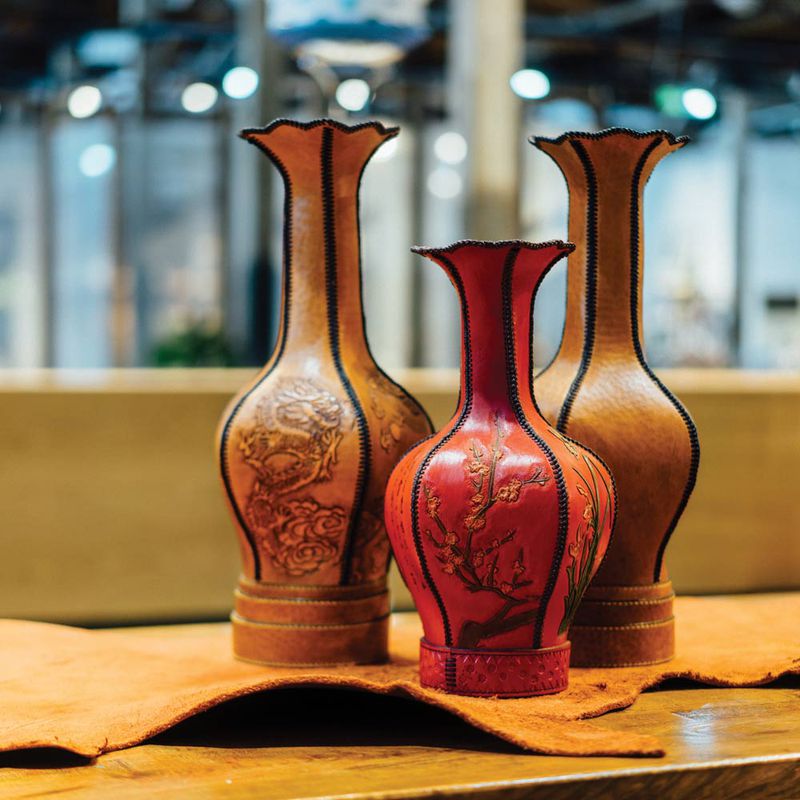 Elegant leather vases are used to hold dried flowers