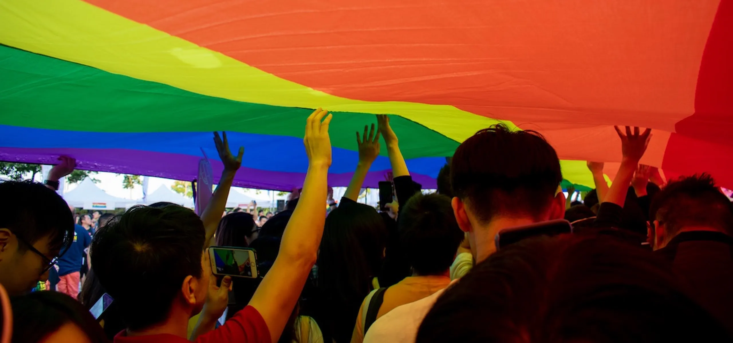 Students under a LGBT flag