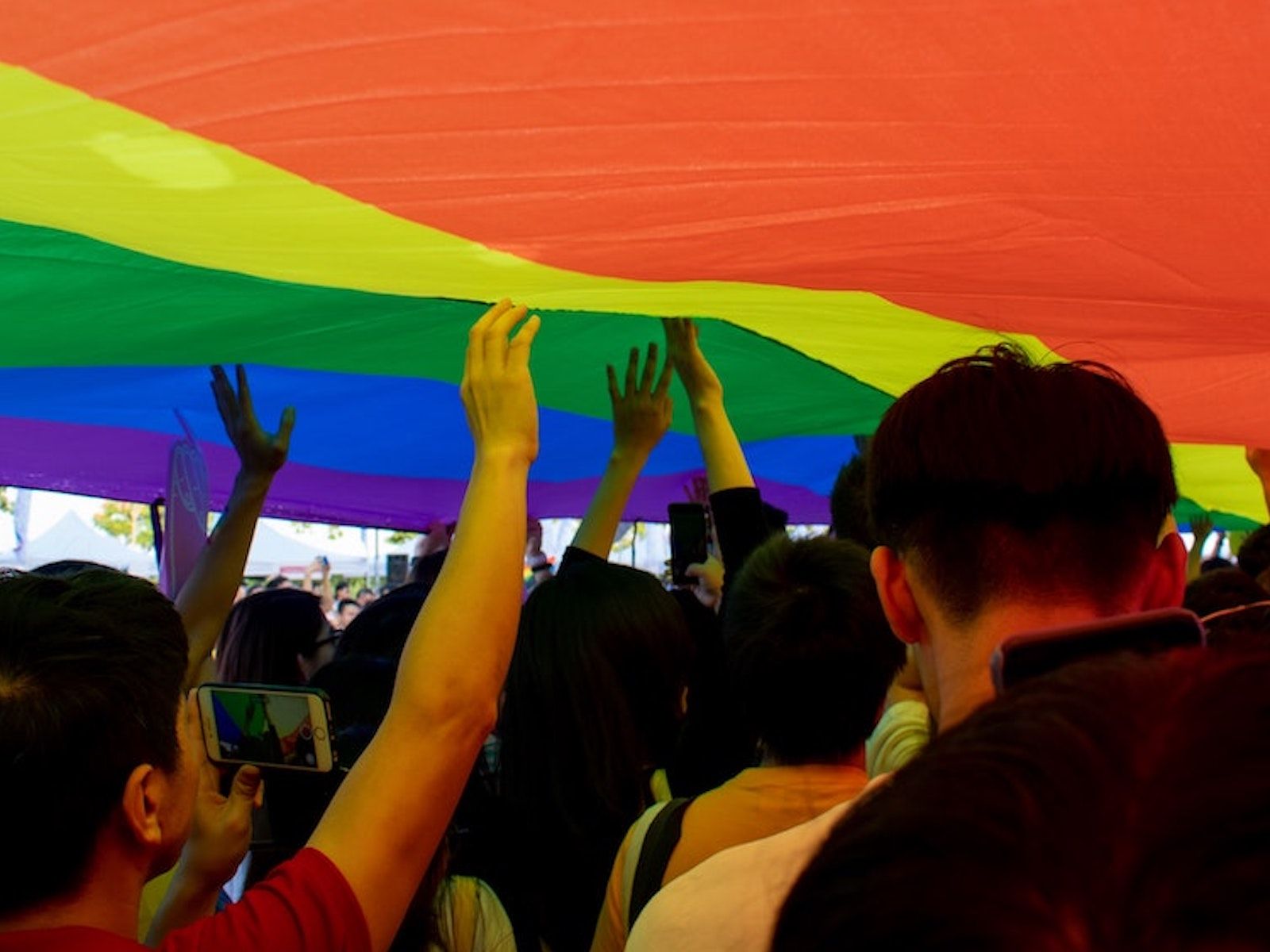 Students under a LGBT flag