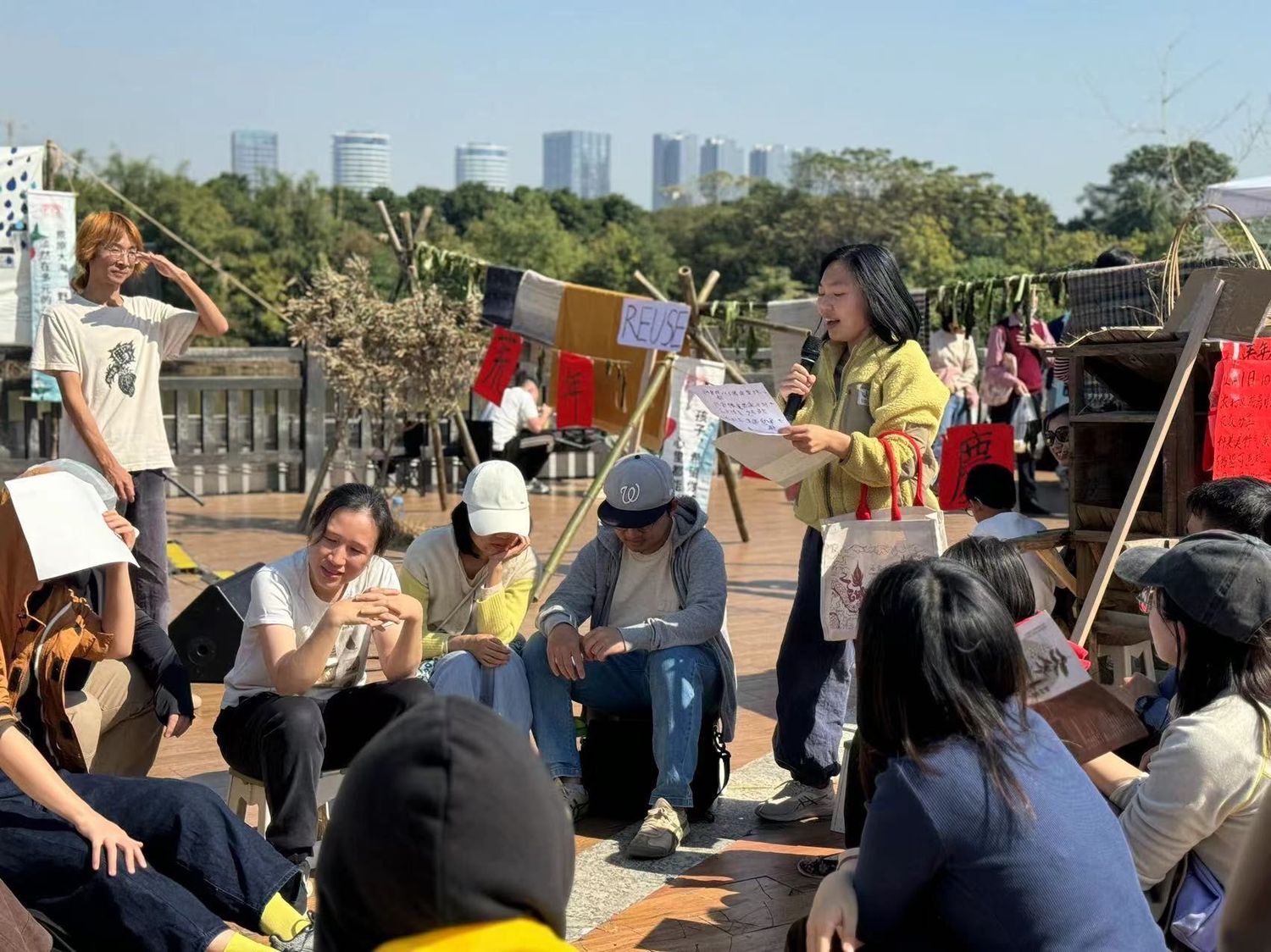 Audiences were divided into groups to discuss potential solutions for farmers experiencing lychee crop loss, as part of the performance