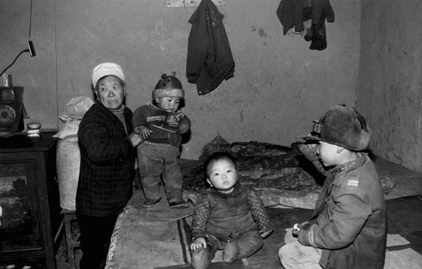 An old matchmaker in her 70s with her adopted children, bought for 200 to 300 RMB each. She will sell them into marriage in later life.