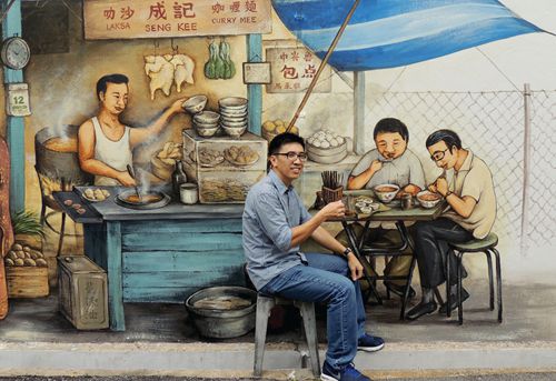 Yip’s (pictured) other work, such as this mural in the Tiong Bahru area, reflect Singapore’s multi-ethnic heritage