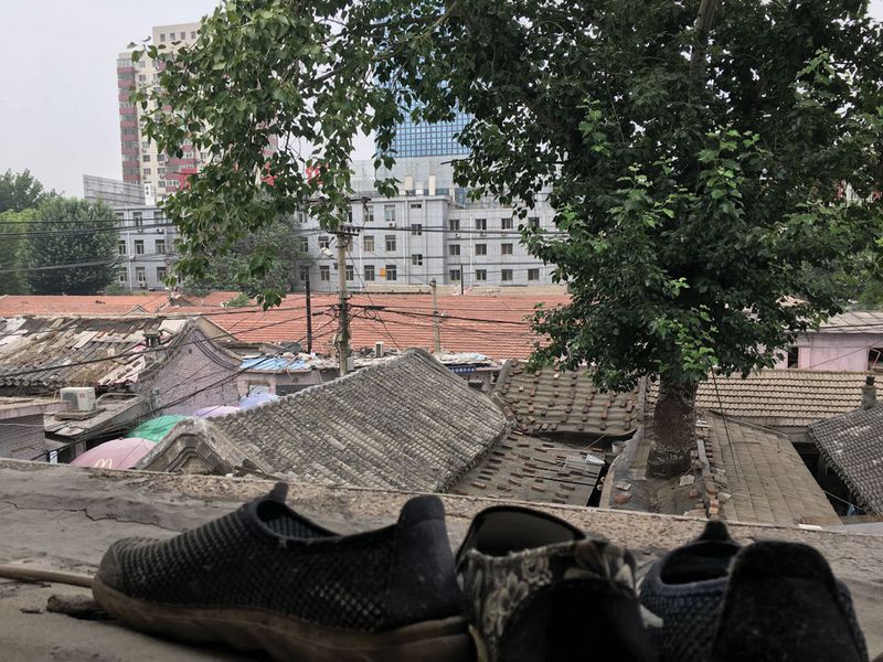 Traditional-style roofs, increasing rare in Beijing, are surrounded by modern apartment blocks