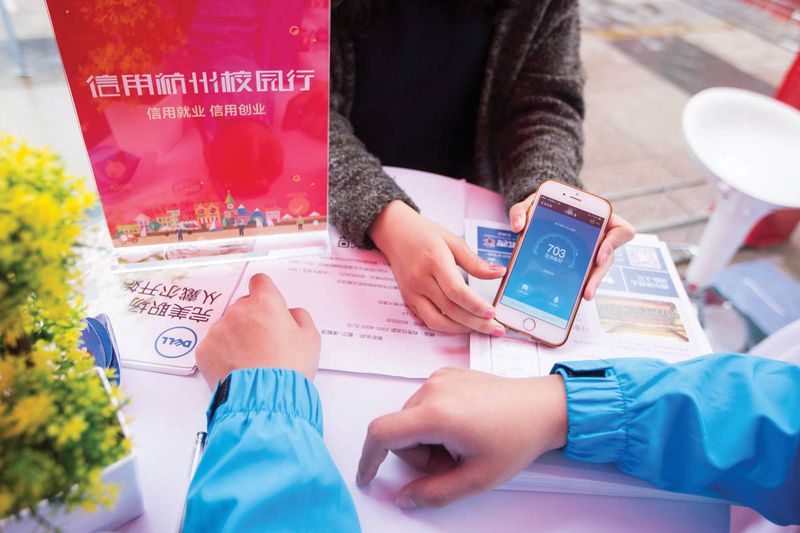 A student shows her Sesame Credit score to a recruiter at a Hangzhou job fair