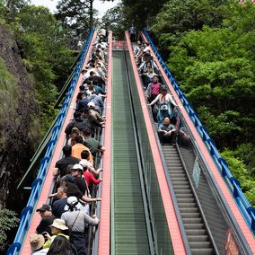 Tourists on escalator in China painless tourism