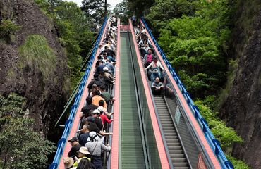 Tourists on escalator in China painless tourism