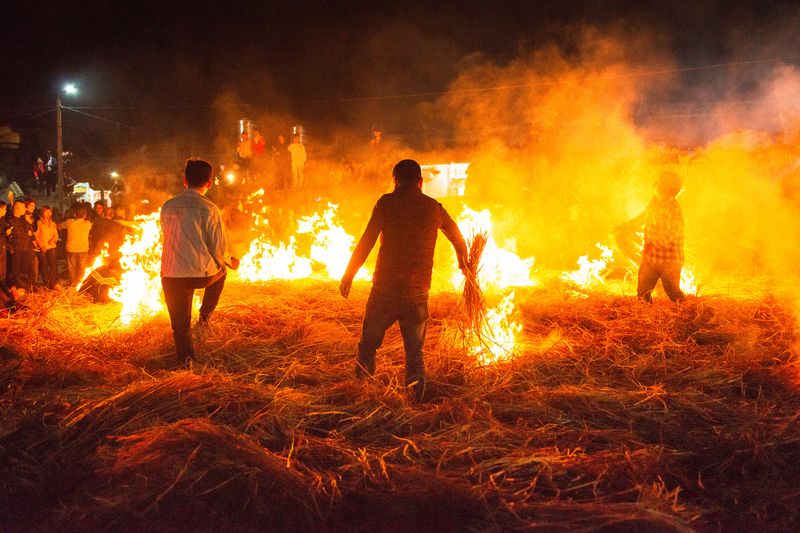 Locals lit up the thick stacks of hay, recreating the scene of a burning battle filed