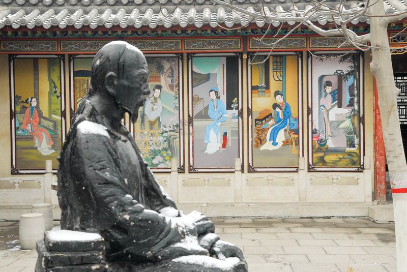 Cao Xueqin&#x27;s statue in the court yard of Cao&#x27;s Memorial Hall in Rongguo Mansion