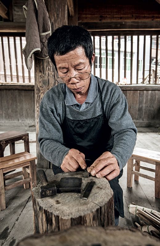 A craftsman make the reed for the Lusheng by hand