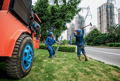 Ground crew prepare the construction of a machine that will help them to draw in the wire