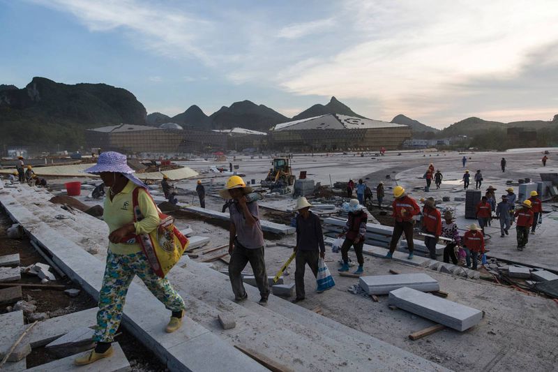 Migrant workers leave the Cultural Park&#x27;s construction site after work