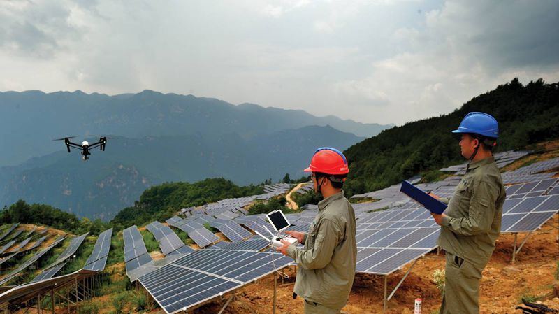 A drone surveys a solar power station for impoverished areas near the Three Gorges Reservoir, Hubei province