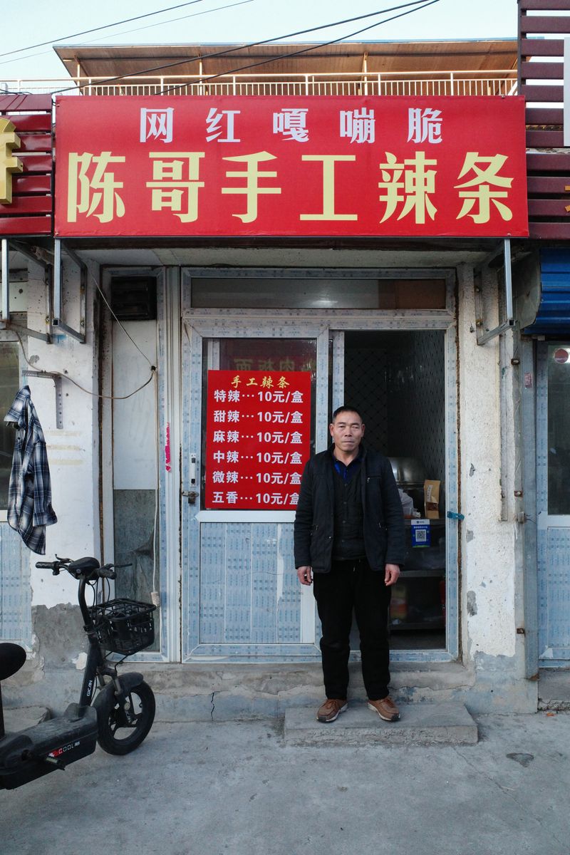 "Latiao" shop manager Xin Xianmin in front his Beijing based shop that makes Henan style latiao, latiao, Chinese snack