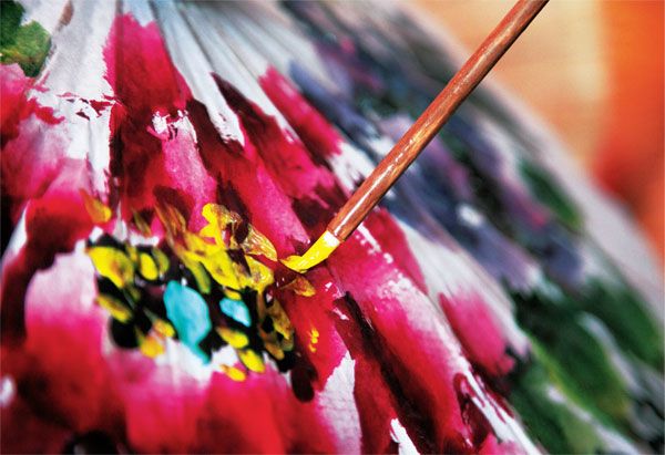 Decorative patterns are added to the delicate umbrellas by hand