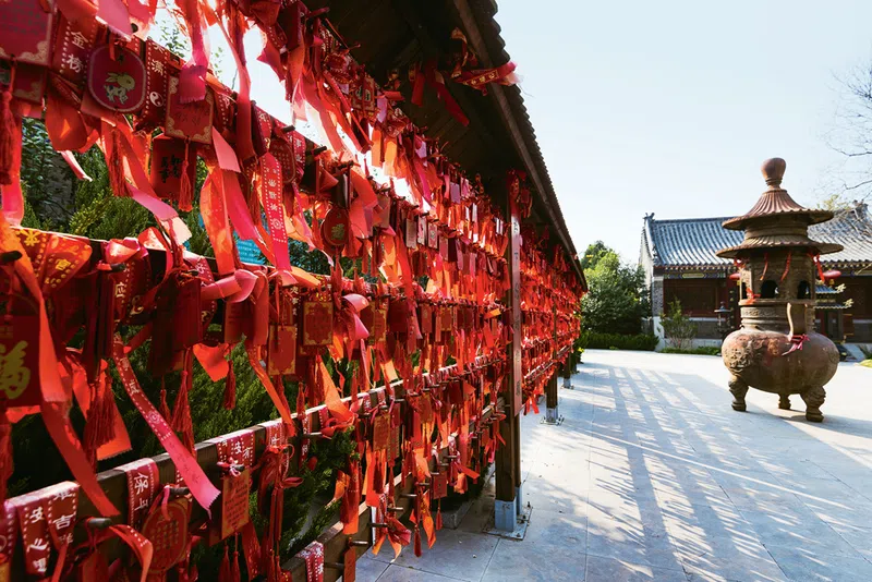 Auspicious red ribbons hanging inside the courtyard of a Daoist temple, one of many ways how Daoism influence in China is displayed.