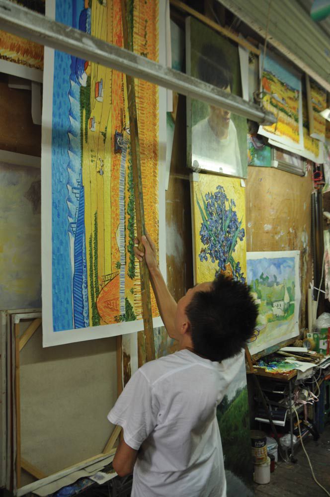 Yang Ming hangs up a painting he just finished