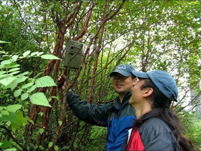 Scientists examine a trap camera