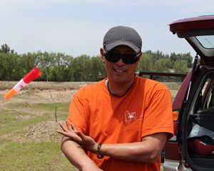 Dollar Zhao testing the speed and direction of the wind so he can get his students in the air