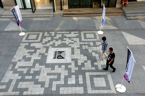 Once a street lined with bookstores, Inno Way went through its own upgrade. Here, pedestrians cross paving stones arranged to resemble a QR code